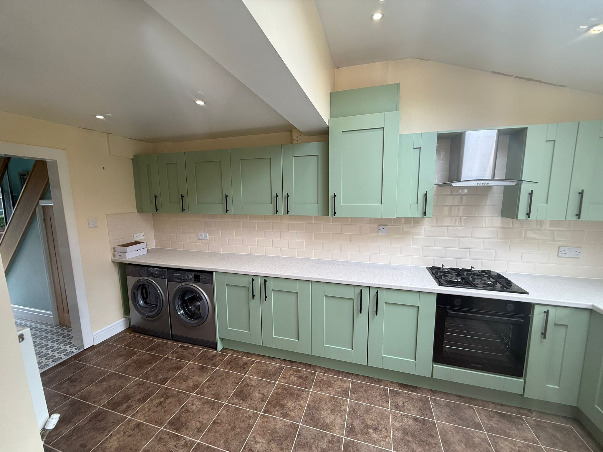 Sage green kitchen cupboard respraying by Saddleworth Spraying Before Image